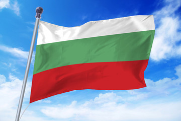 Fototapeta na wymiar Flag of Bulgaria developing against a clear blue sky