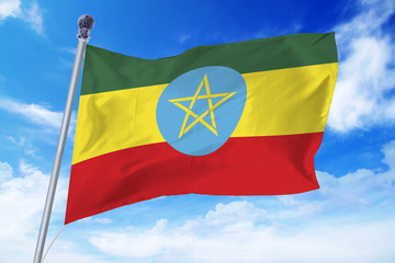 Flag of Ethiopia developing against a clear blue sky