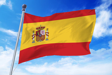 Flag of Spain developing against a clear blue sky
