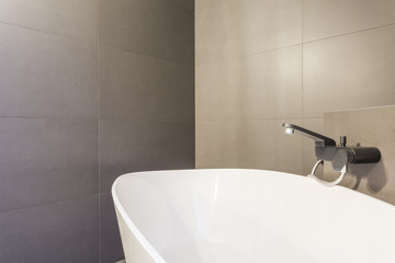 Bath in grey baththroom