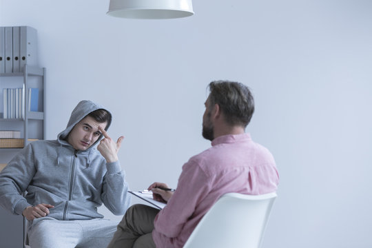 Teenage boy talking with psychologist