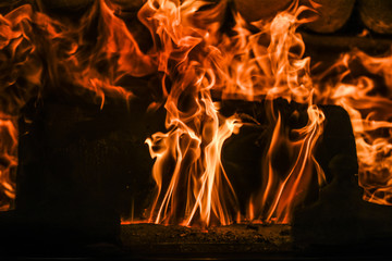 A flames in a fire place.
