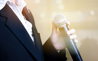 blurred of smart businesswoman speech, presentation talking with microphone, gray scale tone