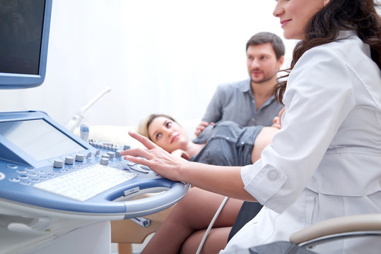 Cropped shot of a female doctor performing ultrasound scanning for her pregnant patient copyspace couple on the background examination diagnosis medical procedure technology health pregnancy.