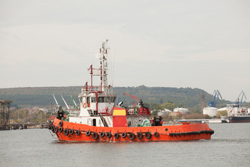Red tug boat in the port