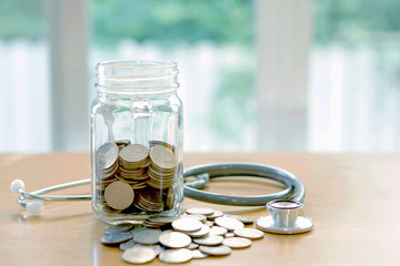 Education budget concept. stethoscopes money savings in a glass