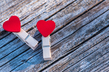 Background on a theme of love. Clothespins in the form of hearts on a beautiful blurred background