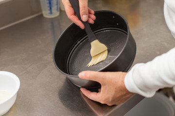 cook preparing mold for cooking