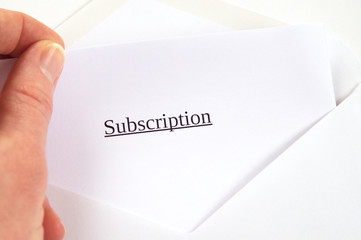 Subscription printed on white paper and envelope, hand holding it, white background