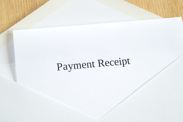 Payment Receipt printed on white paper and envelope, wooden background