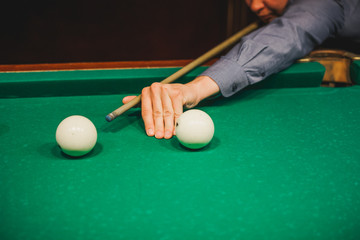 To play billiards. The man plays billiards. Desktop gambling.