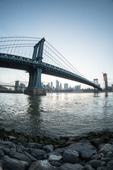 Fototapeta premium An iconic shot of New York City's Manhattan Bridge - DUMBO, Brooklyn. Shot from the Cobblestone of Washington Street during the Spring of 2017 with a Fisheye Lens.