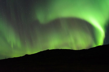 The Aurora in the sky above the hills in the fall.