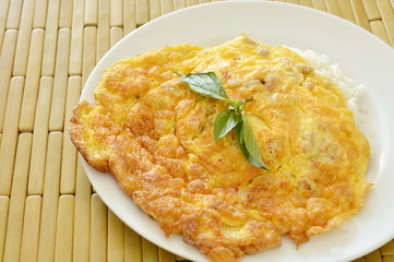 crispy egg omelet stuffed minced pork topping basil leaf on rice