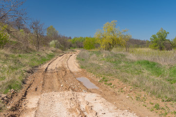 Seasonal landscape with clay dirty road in Ukraine