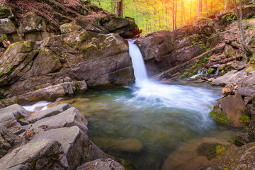 Landscape of river in mountains  and small waterfall. View of stone water rapids  and spring forest.