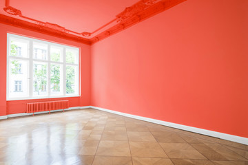 empty room in new apartment, red walls and wooden floor