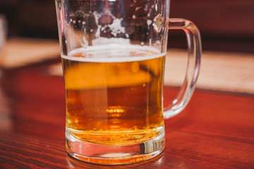 Glass of beer. Golden beer in a circle.