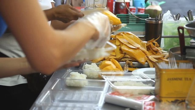Merchant preparing Thai mango dessert