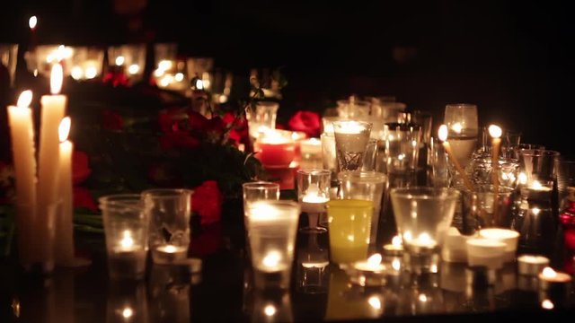 Flowers and candles in memory of the victims of the victims of the terrorist attacks. Politics, terrorism, military actions. People mourn.
