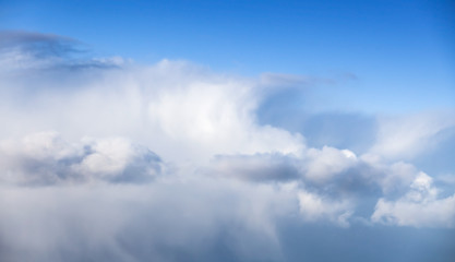 Naklejka na ściany i meble Massive white cumulus clouds in blue sky