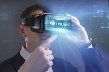 Business, Technology, Internet and network concept. Young businessman working in virtual reality glasses sees the inscription: Referrals