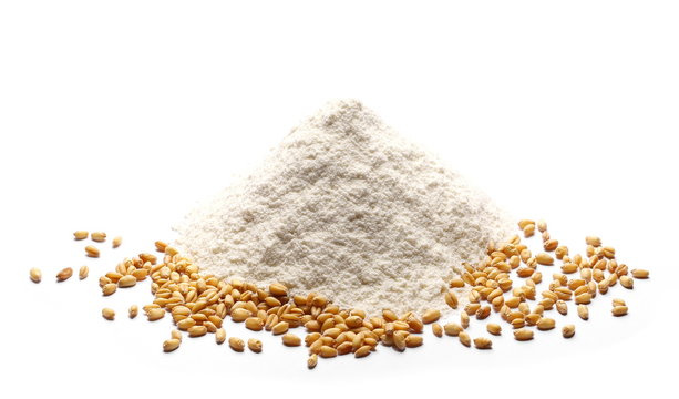 Pile of wheat flour and grains isolated on white background