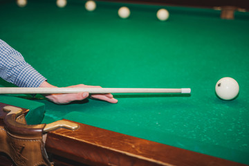 To play billiards. The man plays billiards. Desktop gambling.