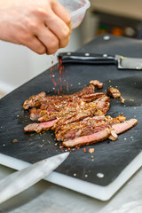 Cook seasoning roasted pork steak