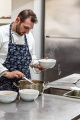 Chef is serving vegetable soup