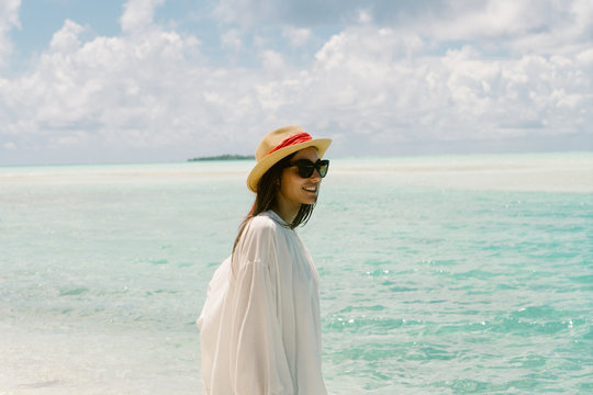 Woman at beach, looking at view, smiling, Tahiti, South Pacific