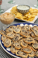 Table with plate of home-made cookies and plate of tortilla chips with dip