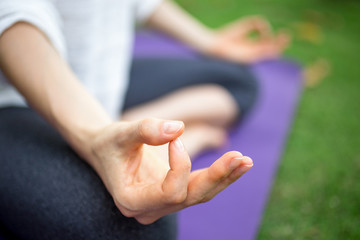 Obraz na płótnie Canvas Extreme close-up of female hand gesturing zen