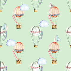 Seamless pattern with watercolor festive air balloons, clouds and cute birds, hand drawn isolated on a green background