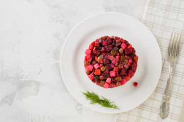 Salad vinaigrette on a plate on a white background. Top view.