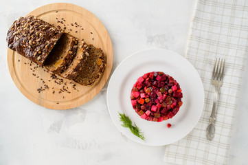 Fresh homemade salad Vinaigrette in a white plate. Traditional Russian food.