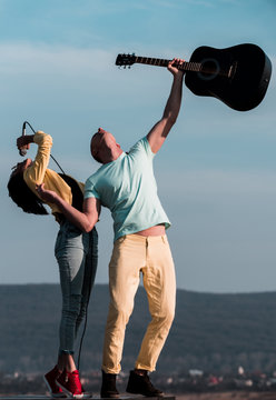 music band of man and woman with guitar and microphone