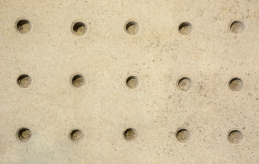 Stone wall patterned with round holes texture background