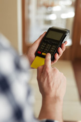 Close up of male hands entering PIN number