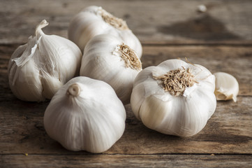 Garlic cloves on wooden vintage background.