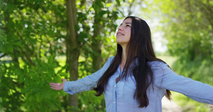 Portrait of a beautiful young girl, breathes in the air and feels free in the background of nature Concept clean ecological air, healthy lifestyle, freedom, cleanliness, happiness and smile fresh air
