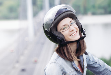 Young happy woman portrait wearing motorcycle helmet