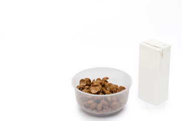 serial with milk in the box for breakfast isolated on white.