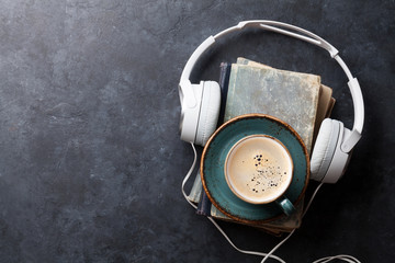 Audio book concept. Headphones, coffee and book
