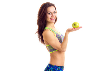 Sportive woman holding apple