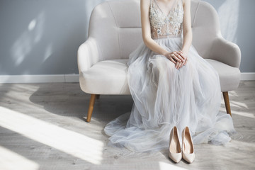 Fototapeta na wymiar A bride wearing wedding shoes in a lace vintage dress