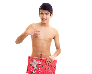 Undressed young man holding present