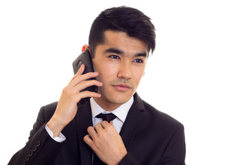 Young man in suit talking on the phone