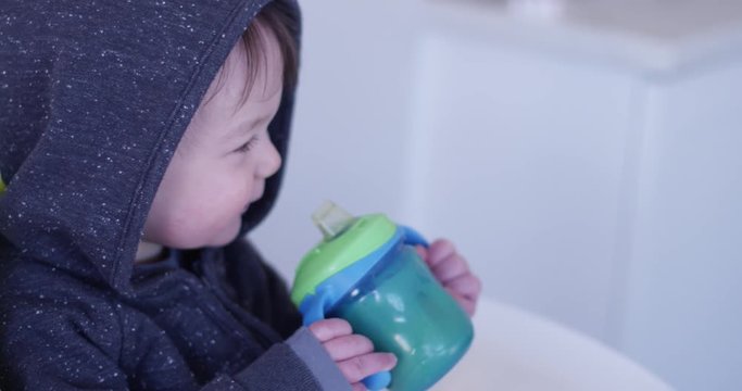 Toddler sipping from sippy cup - slow motion