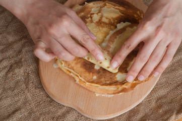  A woman fills pancakes with mashed potatoes